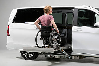 Kassettenlift mit ins Auto fahrendem Rollstuhlfahrer
