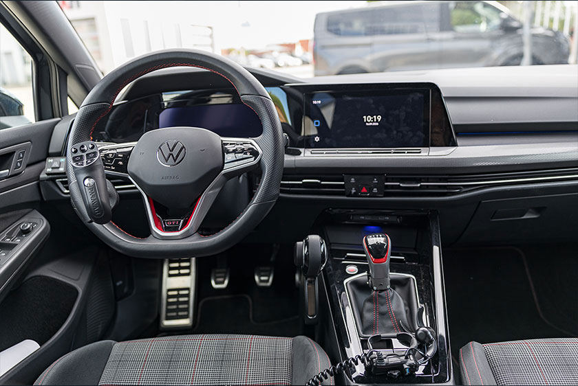 Innenraum des VW Golf GTI mit Clutch-by-Wire-Paddle am Schalthebel und Handbedienung für Gas und Bremse