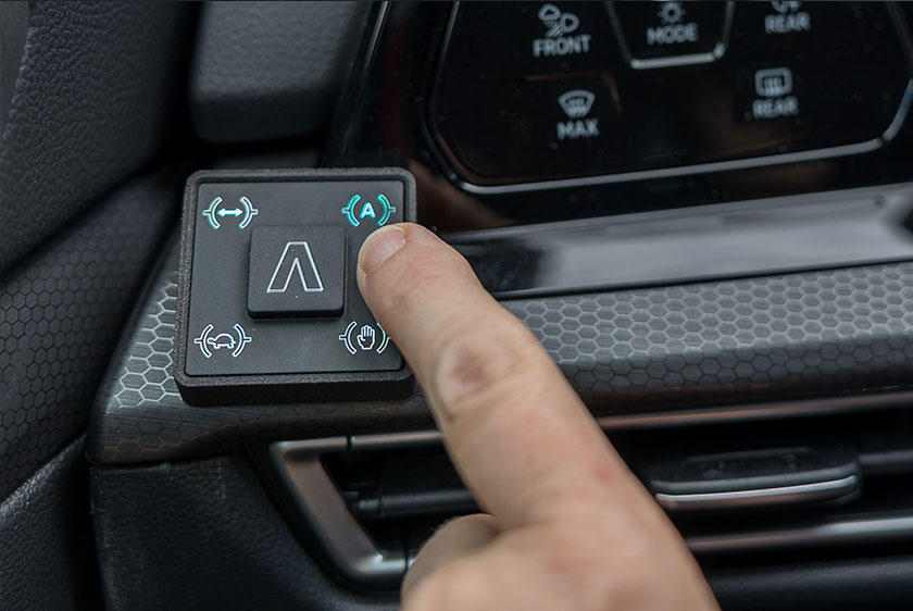 Hand wählt am Bedienteil des PARAVAN Clutch-by-Wire-Systems einen der drei Fahrmodi